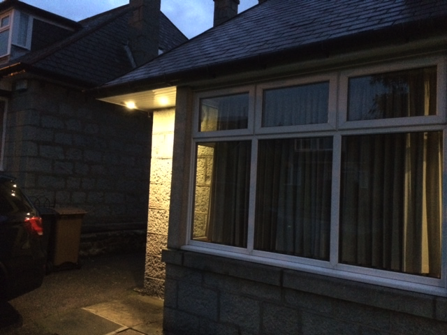 White soffit lights at corner of house.