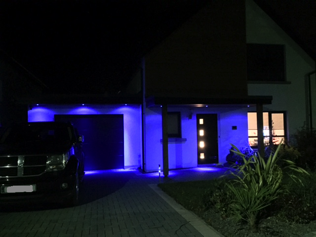 Blue soffit lights over front door & garage.