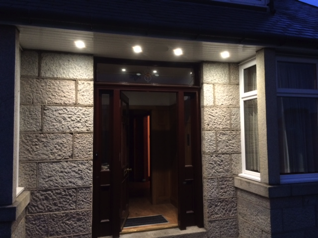 White soffit lights over front door.